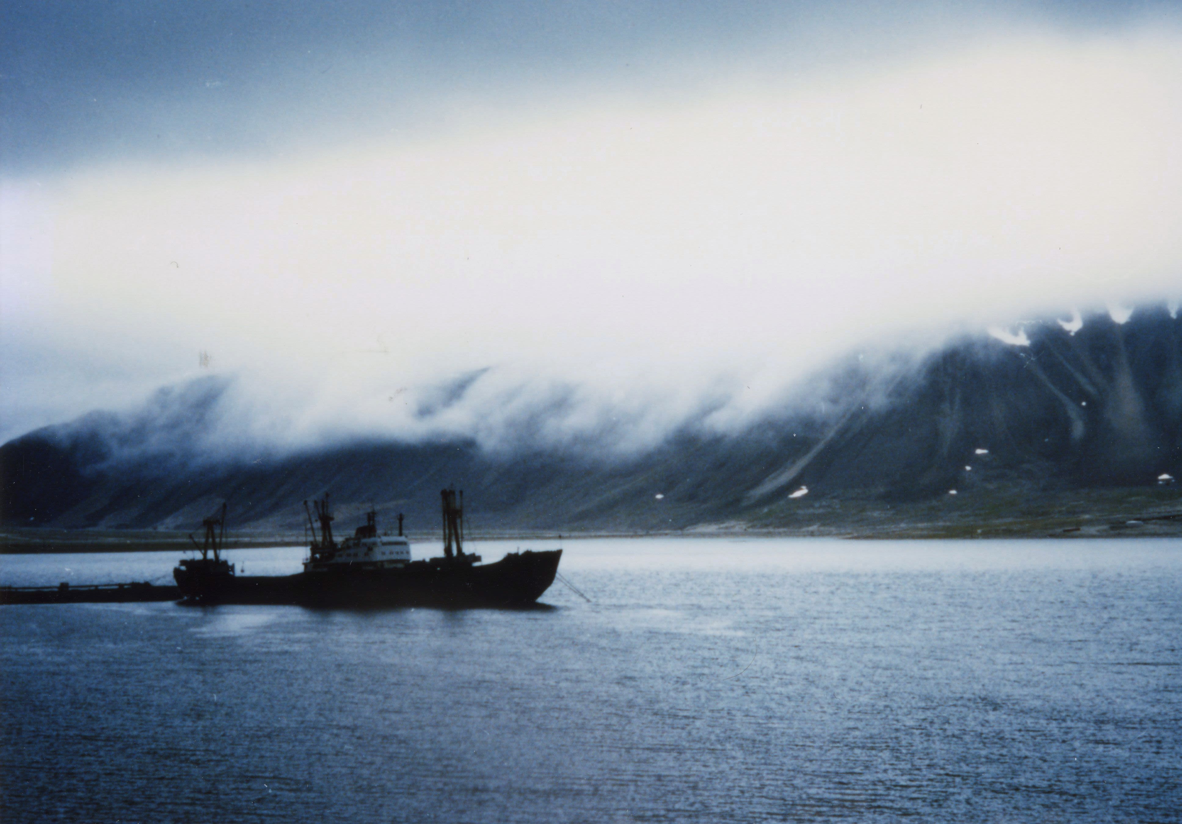 A ship sails past a foggy mountain in Chukotka. Credit: ICC Canada